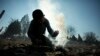 A boy tries to light a fire to warm his body at the refugee camp at Harmanli./UNHCR/D.Kashavelov