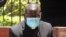 Kenyan Catholic priest Richard Onyango Oduor sits on an open-air dock as he was charged at the Milimani Law Courts with spreading the coronavirus, in Nairobi, Kenya, April 16, 2020. 