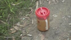 Jugs of diesel fuel are seen on a path in the town of Maungdaw, Western Myanmar. (Photo: Steve Sandford / VOA)