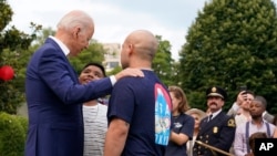 President Joe Biden speaks with attendees during an Independence Day celebration on the South Lawn of the White House, July 4, 2021. 