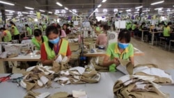 In this Oct. 24, 2017, photo, garment workers sew clothes at Pro Sports factory in Nam Dinh province, Vietnam.