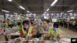 FILE - Garment workers sew clothes at Pro Sports factory in Nam Dinh province, Vietnam. Oct. 24, 2017.