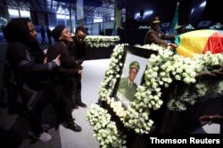Relatives mourn in front of the coffin of the country’s Army Chief of Staff Seare Mekonnen, who was shot by his bodyguard, during a memorial ceremony in Addis Ababa, June 25, 2019.