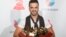 Luis Fonsi holds his awards for Song of the Year, Record of the Year and Best Long Form Music Video for "Despacito" and Best Urban Fusion/Performance for "Despacito (Remix)." 