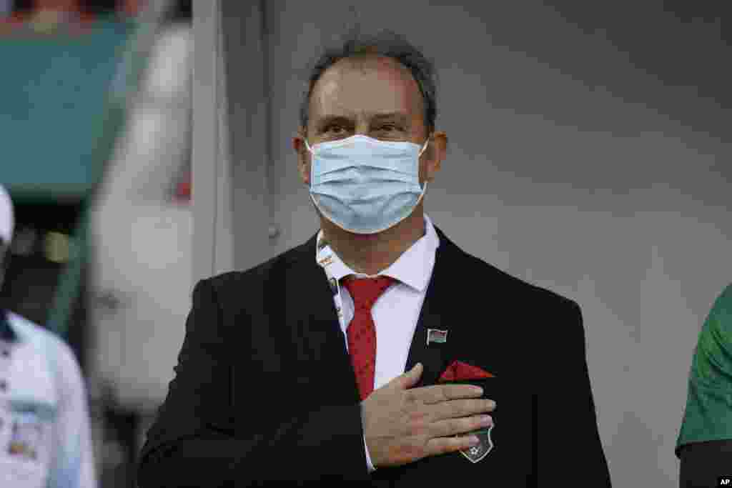 Malawi&#39;s coach Marian Marinica, sing the national anthem before the soccer match between Malawi and Senegal; Cameroon, Jan. 18, 2022. 