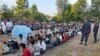 This photo taken on Dec. 16, 2021 by Metta Charity, shows people from Myanmar who fled a surge in violence sitting in lines as they are processed in Mae Tao Phae in Thailand's Mae Sot district.