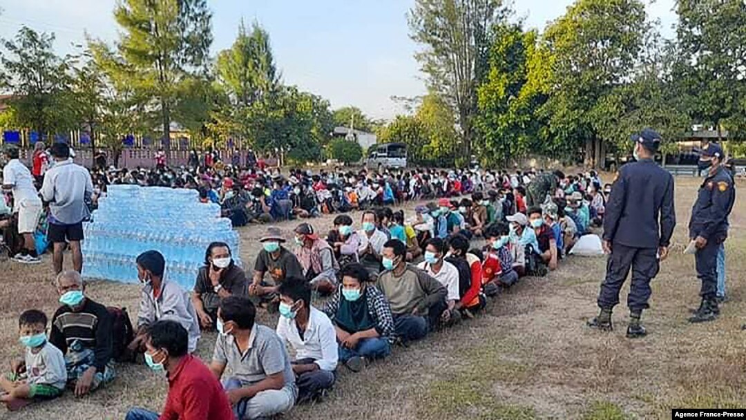 This photo taken on Dec. 16, 2021 by Metta Charity, shows people from Myanmar who fled a surge in violence sitting in lines as they are processed in Mae Tao Phae in Thailand's Mae Sot district.