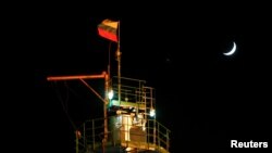 FILE - A Russian national flag flies on the top of a diesel plant in the Yarakta Oil Field, Irkutsk Region, Russia, March 10, 2019.