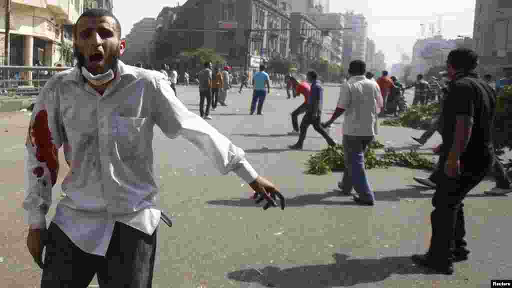 A member of the Muslim Brotherhood and supporter of ousted Egyptian President Mursi shouts slogans.