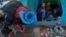 A migrant family waits in their tent on the street for buses to carry them to a new shelter, in Tijuana, Mexico, Dec. 1, 2018. Most of the thousands of migrants who had been camped out at the sports complex had agreed to move to the new, more distant shel