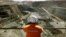 FILE - A miner looks across the largest open pit gold mine in Australia called the Fimiston Open Pit, also known as the Super Pit, in the gold-mining town of Kalgoorlie, located around 500 kilometres east of Perth, July 27, 2001. 