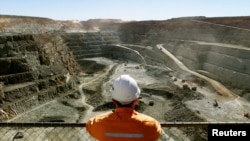 FILE - A miner looks across the largest open pit gold mine in Australia called the Fimiston Open Pit, also known as the Super Pit, in the gold-mining town of Kalgoorlie, located around 500 kilometres east of Perth, July 27, 2001. 