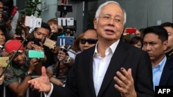 FILE - Malaysia's former Prime Minister Najib Razak speaks to the media after being questioned at the Malaysian Anti-Corruption Commission (MACC) office in Putrajaya, May 24, 2018.