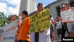 FILE - Faculty and staff at the University of Texas protest against a state law that allows for guns in classrooms at college campuses, in Austin, Texas, U.S. August 24, 2016.