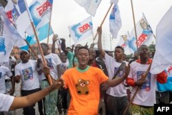 FILE —Supporters for a re-election of the Incumbent President of the DRC and presidential candidate Felix Tshisekedi attend his first campaign rally ahead of the 2023 general elections in Kinshasa on November 19, 2023.