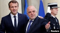 French President Emmanuel Macron welcomes Iraqi Prime Minister Haider Al-Abadi at the Elysee Palace in Paris, Oct. 5, 2017. 