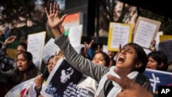 FILE - An Indian woman shouts slogans during a protest outside police headquarters against alleged police negligence in the murder and suspected rape of a woman in New Delhi, India, Jan. 13, 2015.