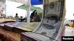 FILE - Banknotes are displayed on a roadside currency exchange stall along a street in Juba. South Sudan's Central Bank has run out of foreign cash reserves, a senior bank official said, Aug. 20, 2020.