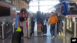 This image taken from video shows passengers inside Marseille-Saint-Charles railway station in Marseille, France, Sept. 17, 2017. 