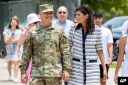 FILE —Republican presidential candidate Nikki Haley walks with her husband Maj. Michael Haley following a deployment ceremony for his unit of the South Carolina National Guard on June 17, 2023, at Johnson Hagood Stadium in Charleston, S.C.