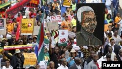 Demonstrators carry placards during a march against xenophobia in downtown Johannesburg, April 23, 2015.