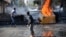 FILE - Youths set fire to barricades in Diyarbakir, Turkey, hours after Kurds protesting the Islamic State advance on Kobani, Syria, had clashed with police, Oct. 8, 2014. 