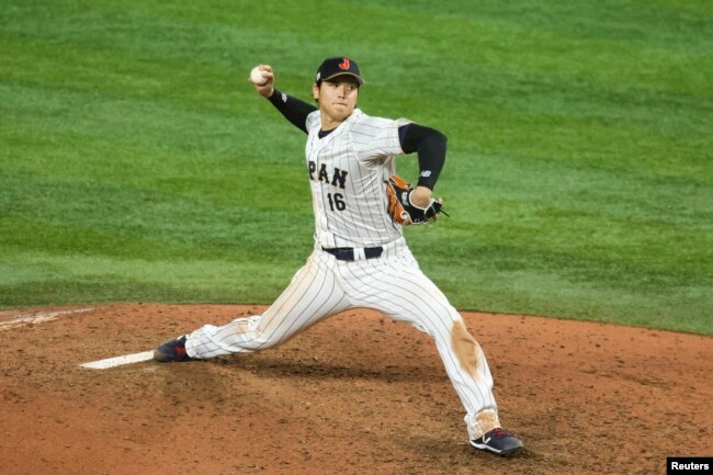 Japan pitcher Shohei Ohtani delivers a pitch during the ninth inning against the USA at LoanDepot Park in Miami on Mar. 21, 2023. (Sam Navarro-USA TODAY Sports)