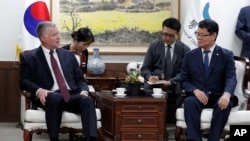 South Korean Unification Minister Kim Yeon Chul, right, and U.S. Special Representative for North Korea Stephen Biegun, left, talk during their meeting at a government complex in downtown Seoul, South Korea, Wednesday, Aug. 21, 2019. 