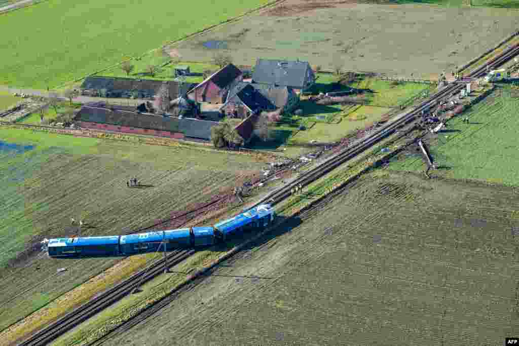 Emergency services workers are on the scene of a derailed passengers train near Dalfsen, eastern Netherlands. A passenger train went off the tracks after it collided with a hydraulic crane, leaving the train driver dead and seven people injured, local officials said.