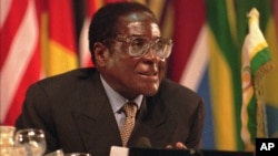 FILE: Zimbabwean President Robert Mugabe speaks during the opening ceremony of the Organization of African Unity summit in Harare,Zimbabwe, on Monday, June 2,1997. 