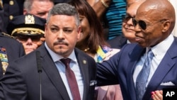 FILE - Edward Caban, left, speaks after being sworn in as NYPD police commissioner outside New York City Police Department 40th Precinct, July 17, 2023, in New York. Mayor Eric Adams on the right.