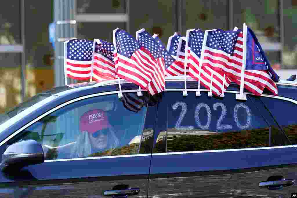 A protester joins a caravan outside of City Hall in Los Angeles. Demonstrators, supporting President Donald Trump, are gathering in various parts of Southern California as Congress debates to affirm President-elect Joe Biden&#39;s&#160;electoral victory.