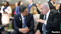 Israeli Prime Minister Benjamin Netanyahu speaks with Honduras' President Juan Orlando Hernandez during a meeting in Brasilia, Brazil, Jan. 1, 2019. 