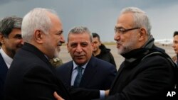 Iran's Foreign Minister Mohammad Javad Zarif, left, is greeted by Lebanese Minister of State Parliamentary Affairs and a member of Hezbollah politicians block Mahmoud Qmati, on his arrival at Rafik Hariri Airport, in Beirut, Feb. 10, 2019. 