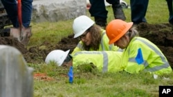 FILE - Oklahoma state archaeologist Kary Stackelbeck, center, watches as excavation begins at Oaklawn Cemetery in a search for victims of the Tulsa Race Massacre, on June 1, 2021, in Tulsa. She announced on Aug. 16, 2024, that three more bodies were found with gunshot wounds.