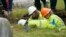 FILE - Oklahoma state archaeologist Kary Stackelbeck, center, watches as excavation begins at Oaklawn Cemetery in a search for victims of the Tulsa Race Massacre, on June 1, 2021, in Tulsa. She announced on Aug. 16, 2024, that three more bodies were found with gunshot wounds.
