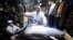 Kiyoshi Kimura, center, president of Kiyomura Co., poses with a bluefin tuna he bought at the annual New Year auction, at his Sushi Zanmai restaurant near Tsukiji fish market in Tokyo, Jan. 5, 2018. This year's top per kilogram price, for a smaller tuna, was $1,419.