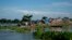 FILE- In this July 31, 2016, file photo, flood affected villagers take shelter on the elevated portion of a submerged road in Morigaon district, east of Gauhati, northeastern Assam state, India.
