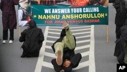 FILE - Militants who claim that they are ready depart to fight the war in Syria, perform martial art techniques during a show of force in Solo, Central Java, Indonesia. 