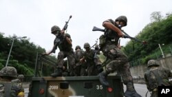 FILE - South Korean army soldiers get off a truck during an anti-terror exercise as part of Ulchi Freedom Guardian in Seoul, South Korea, Aug. 18, 2014.