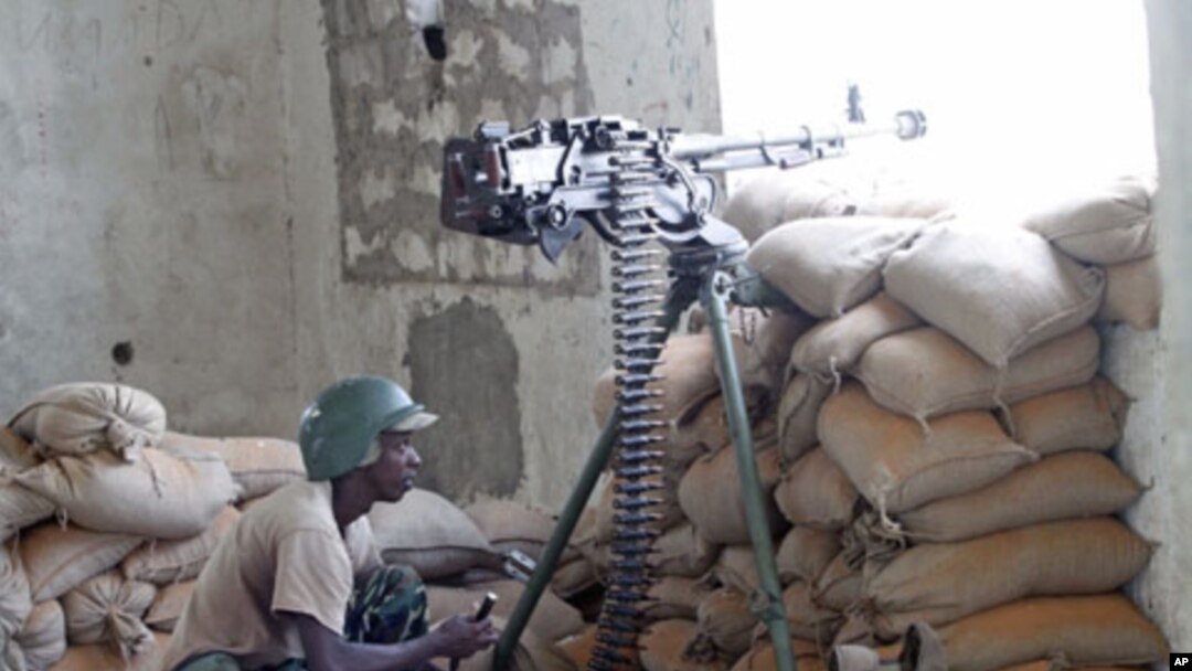 A soldier of the African Union Mission in Somalia takes his position during fighting between Islamists and government forces, in southern Mogadishu, February 14, 2012.