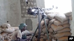 A soldier of the African Union Mission in Somalia takes his position during fighting between Islamists and government forces, in southern Mogadishu, February 14, 2012.