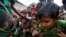 FILE - Rohingya refugee children struggle as they wait to receive food outside the distribution center at Palong Khali refugee camp near Cox's Bazar, Bangladesh, Nov. 17, 2017. 