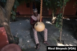 Nino Galissa, a seventh-generation griot — or oral historian — composed the musical version of the Kansala 2024 excavation report. Here, he plays a traditional instrument known as a kora at his home in Bissau, Guinea-Bissau, Nov. 28, 2024.