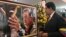 Venezuela's acting President Nicolas Maduro stands in front of a portrait of Venezuela's late President Hugo Chavez after a symbolic swearing in ceremony, March 8, 2013.
