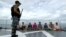 FILE - An Indonesian soldier stands guard near detained Vietnamese fisherman onboard Indonesian warship, KRI Barakuda 633, off the Natuna Sea in Anambas, Kepulauan Riau province, Dec. 5, 2014.