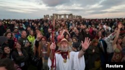 Revelers celebrate the summer solstice at Stonehenge on Salisbury Plain in southern England, June 21, 2016. 