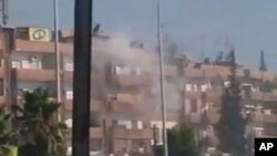 Smoke rises from a building in the Al Hader area of Hama.