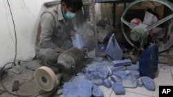 An Afghan man works at a lapis lazuli factory in the city of Kabul, Afghanistan. An international anti-corruption watchdog says Afghanistan's war is being fueled by the country's mining sector, with the Taliban earning up to $20 million a year from illegal mining of lapis lazuli on March 28, 2016.