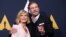 FILE - Cast members John Travolta and Olivia Newton-John pose at a 40th anniversary screening of "Grease" at the Academy of Motion Picture Arts and Sciences in Beverly Hills, California, Aug. 15, 2018.